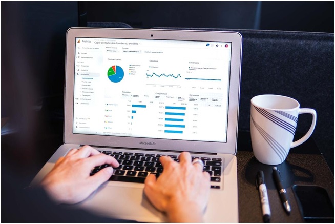 A person on a laptop is looking at data analytics